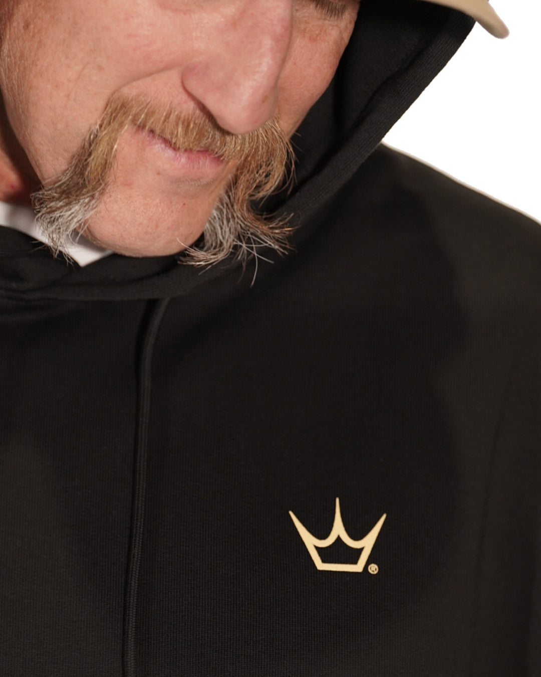 Close-up of Peaty's branding and fabric details on the black Thirsty Work Hoodie