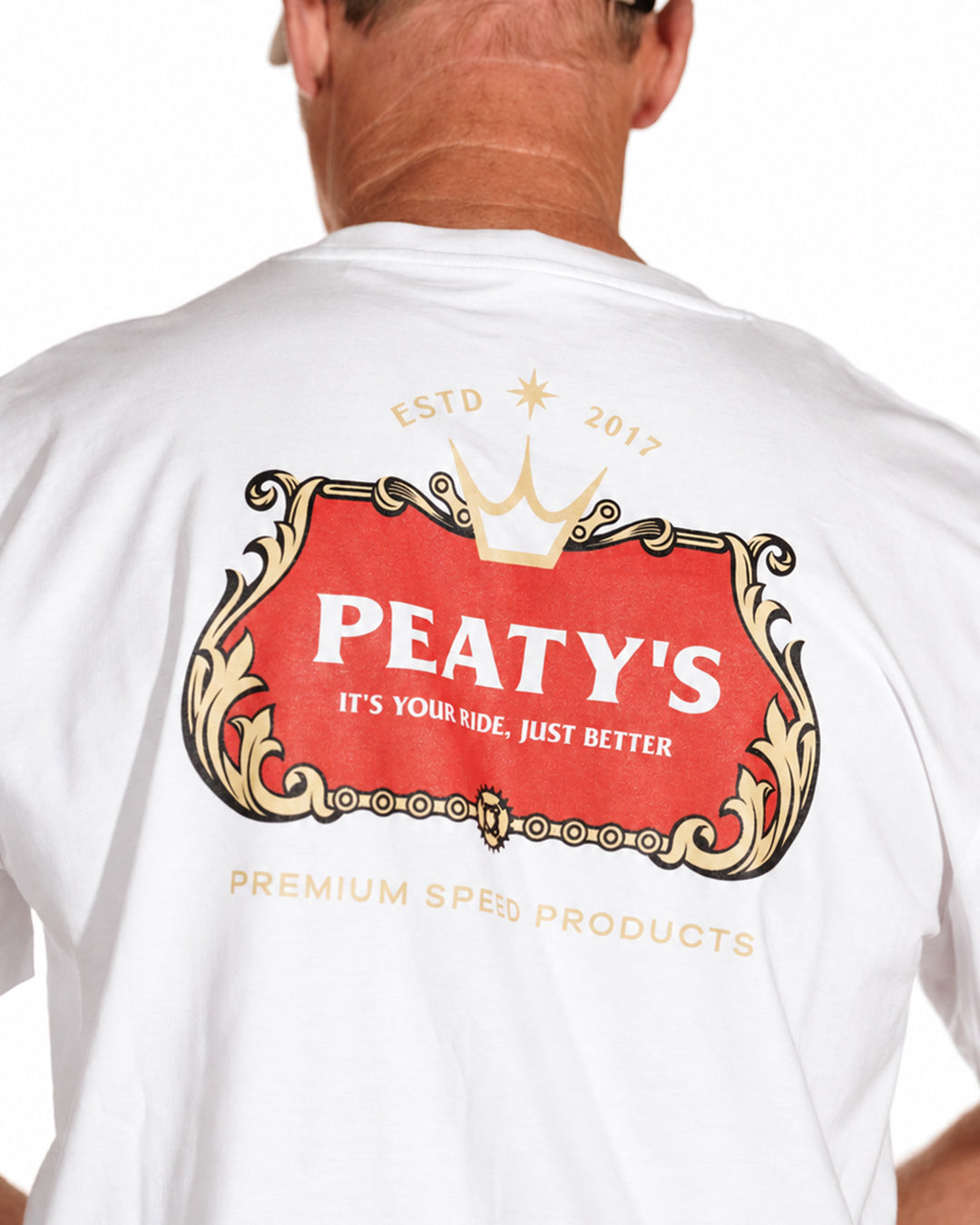 Close-up of the red and gold Thirsty Work graphic on the white Peaty's T-shirt
