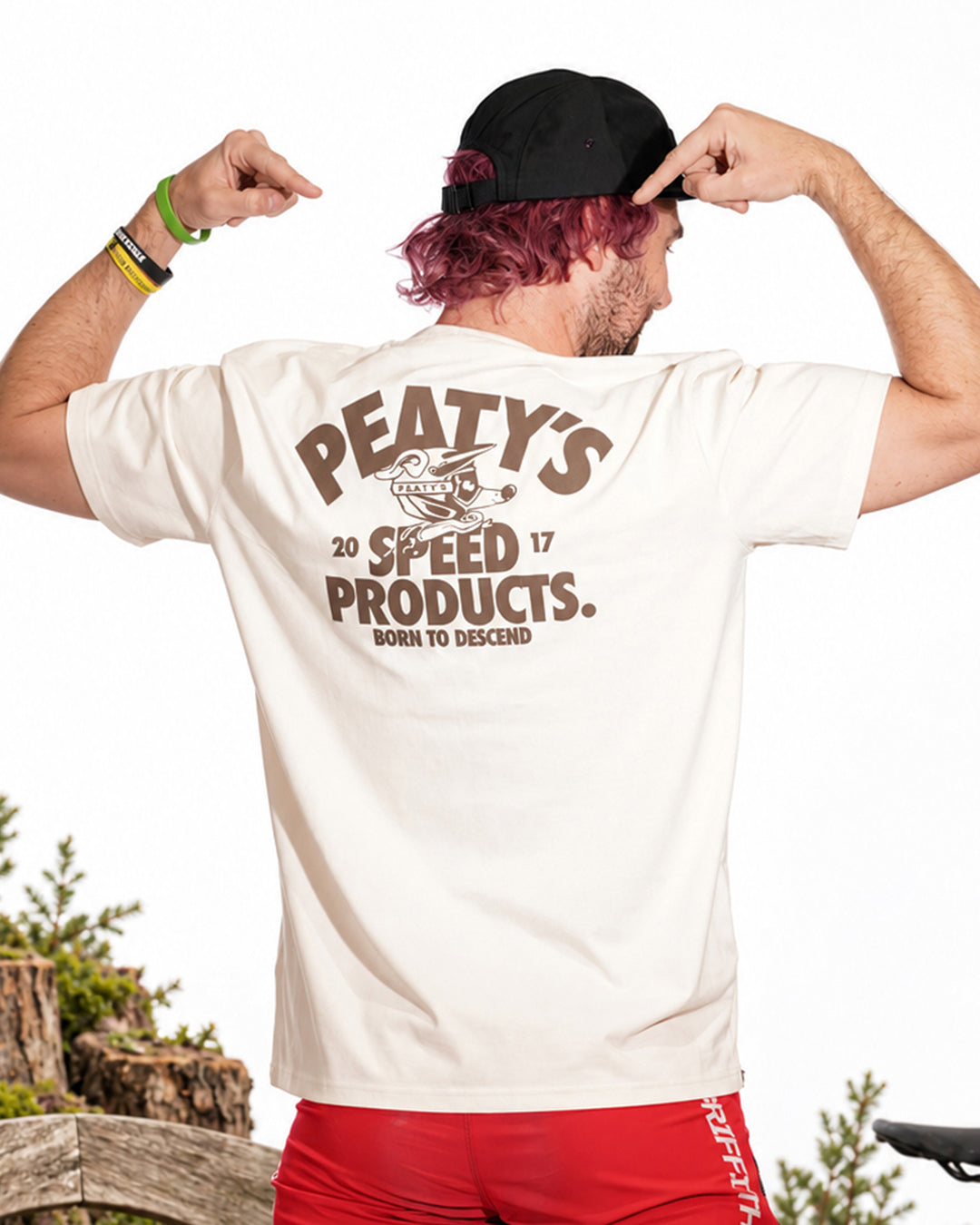 Rider modelling Vintage White Peaty's Descend T-shirt, showing the large back print