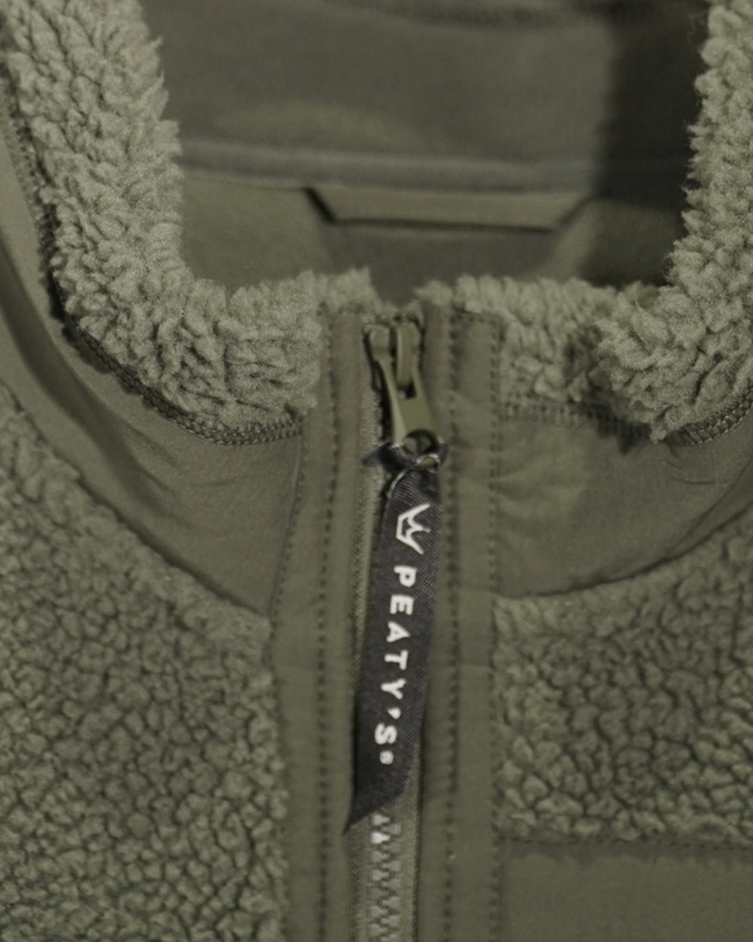 Khaki Wharncliffe Fleece close-up showing lined collar and Peaty's branded zip pull