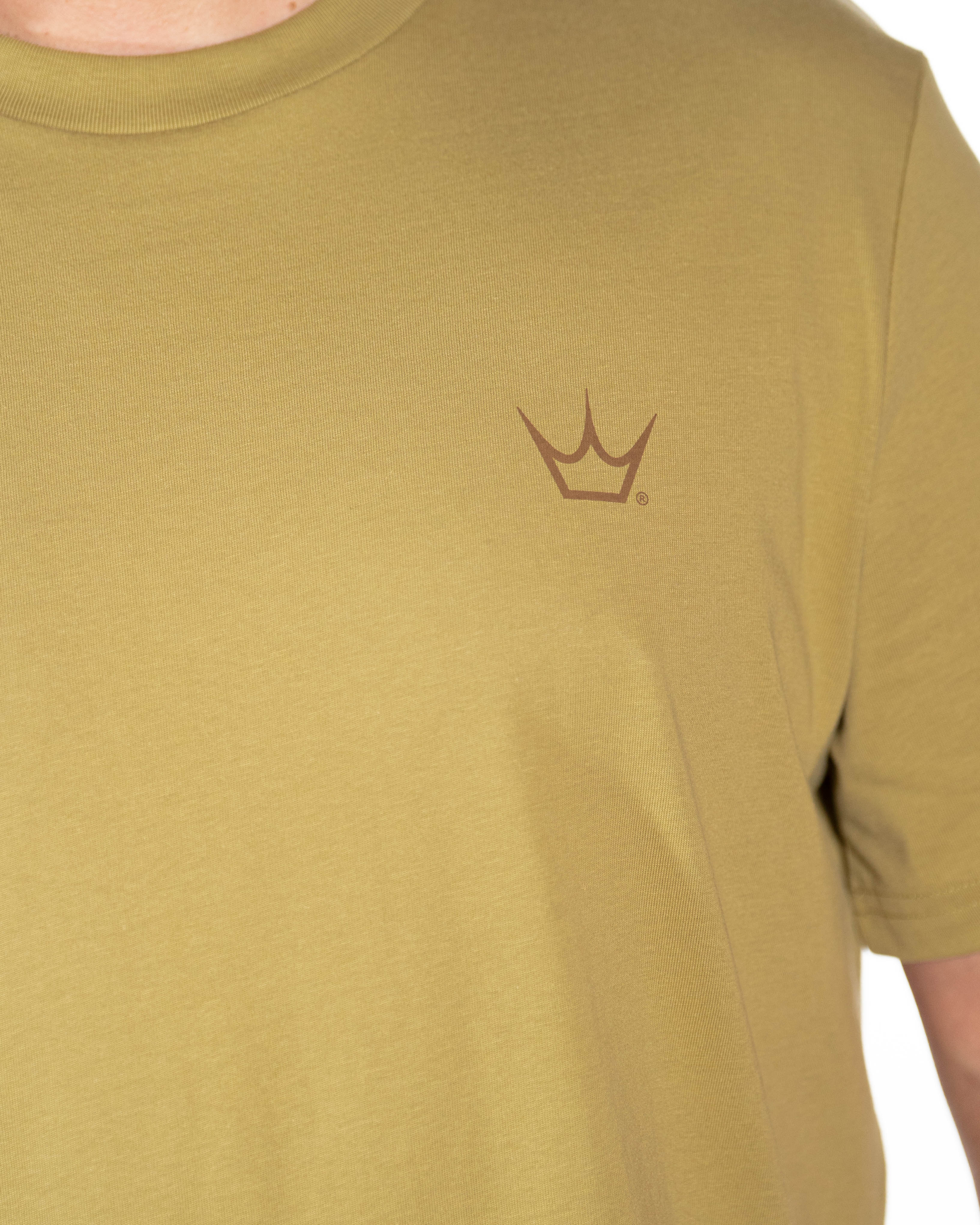 Close-up of the crown chest branding and cotton fabric on the Olive Peaty's Dusk to Dawn T-shirt