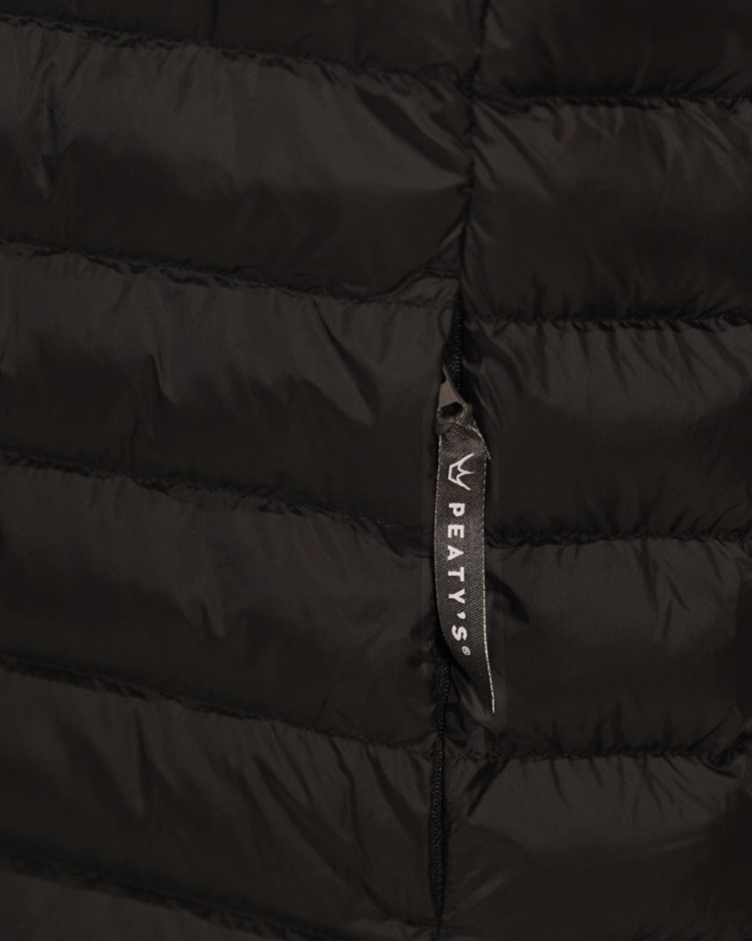Black Grenoside Gilet close-up of Peaty's branded pocket zip