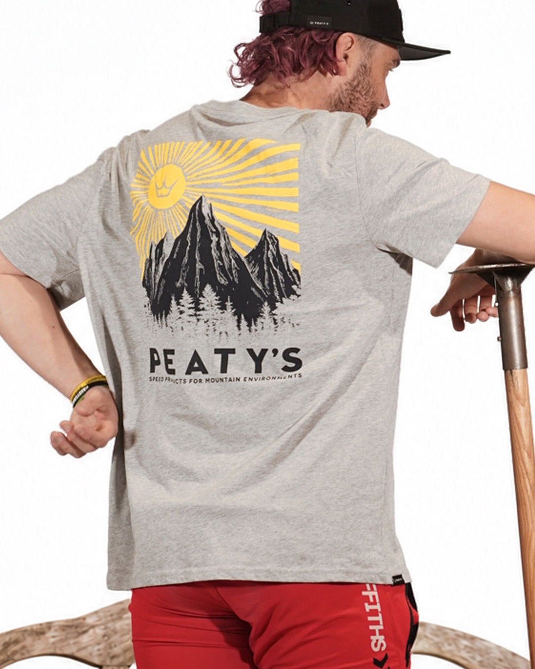 Rider wearing Peaty's Mountain T-shirt in Heather Grey, showing the mountain back graphic