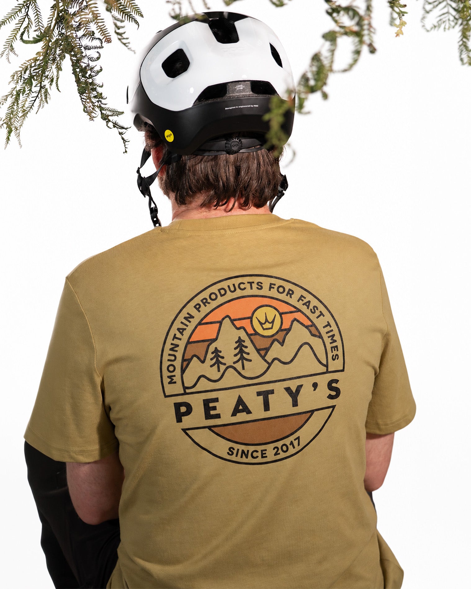 Rider wearing the Faded Olive Peaty's Playground T-shirt, showing the mountain and forest back print