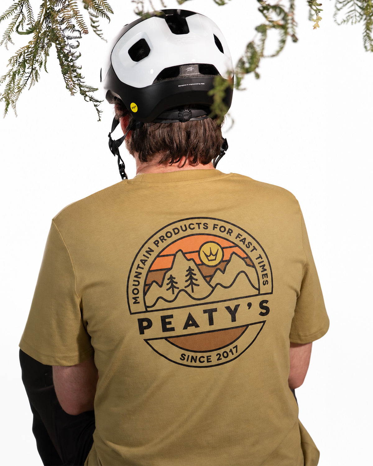 Rider wearing the Faded Olive Peaty's Playground T-shirt, showing the mountain and forest back print